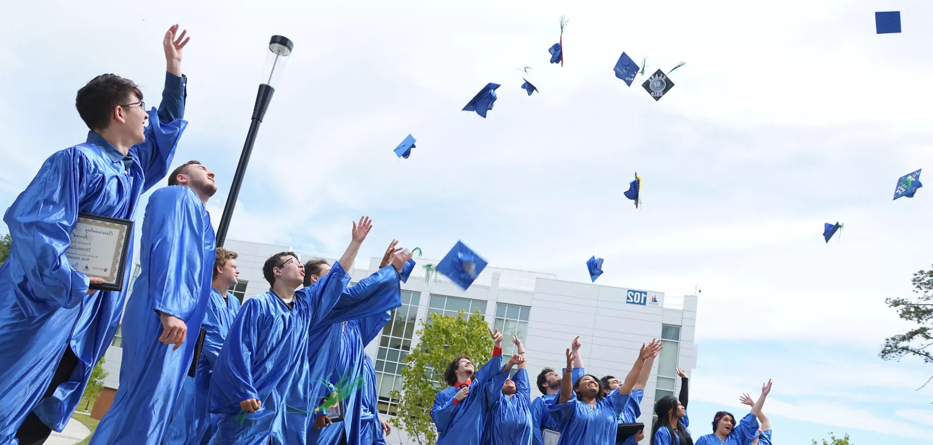 Graduates throwing their caps at graduation